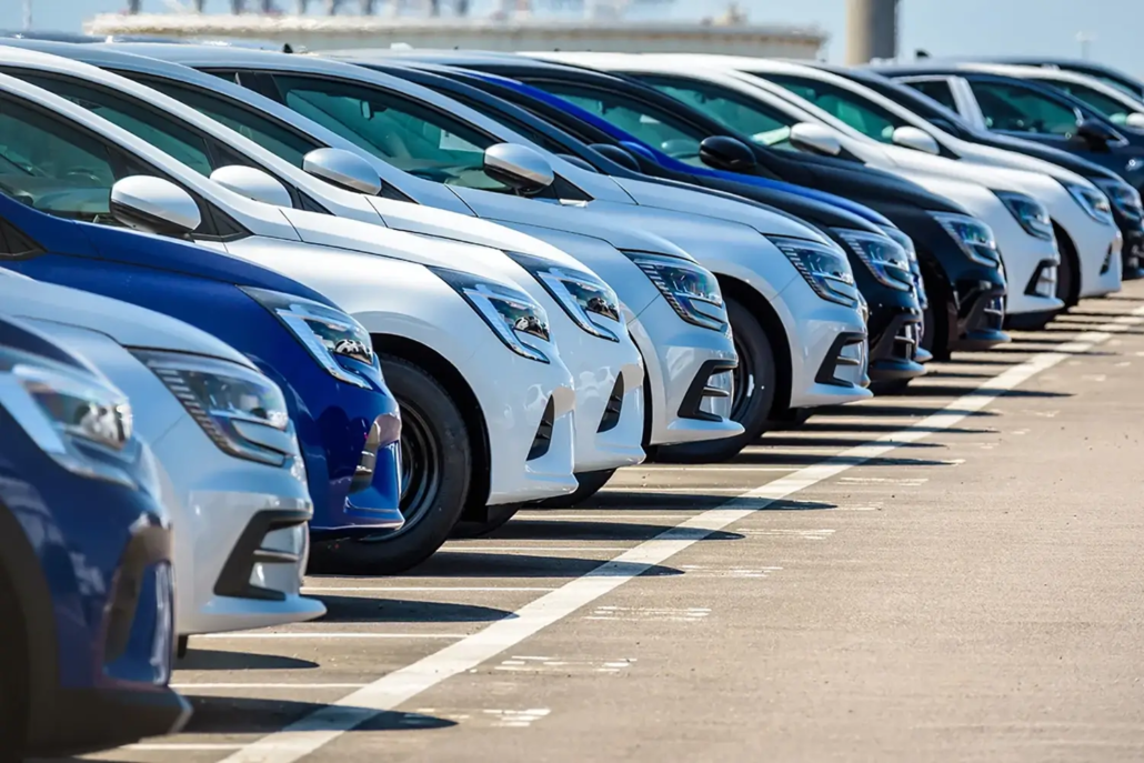 Rows of parked cars in various shades of blue, white, and silver, neatly lined up in a parking lot on a sunny day—ideal for those seeking Used Car Valuations Brisbane.
