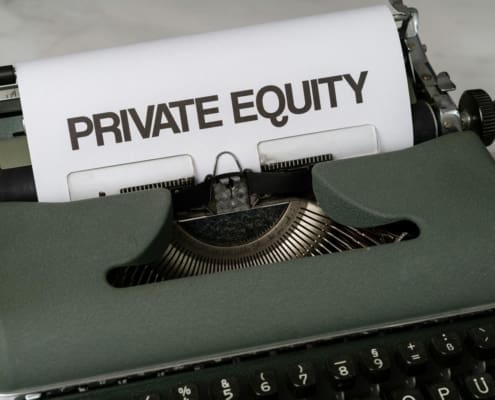 Close-up of vintage typewriter with 'PRIVATE EQUITY' on paper, business concept.