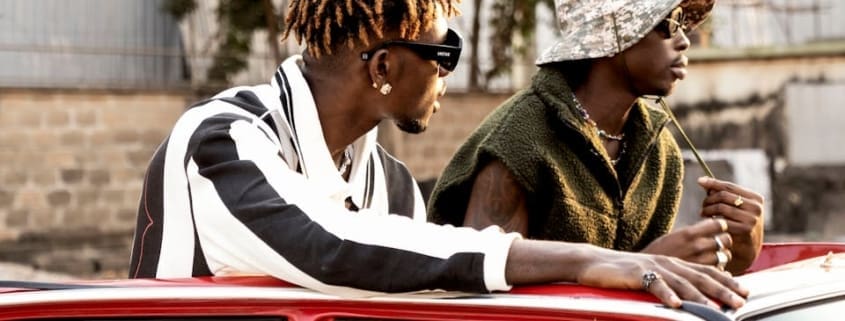Stylish young men in Lagos, Nigeria, enjoying an urban setting in fashionable attire.