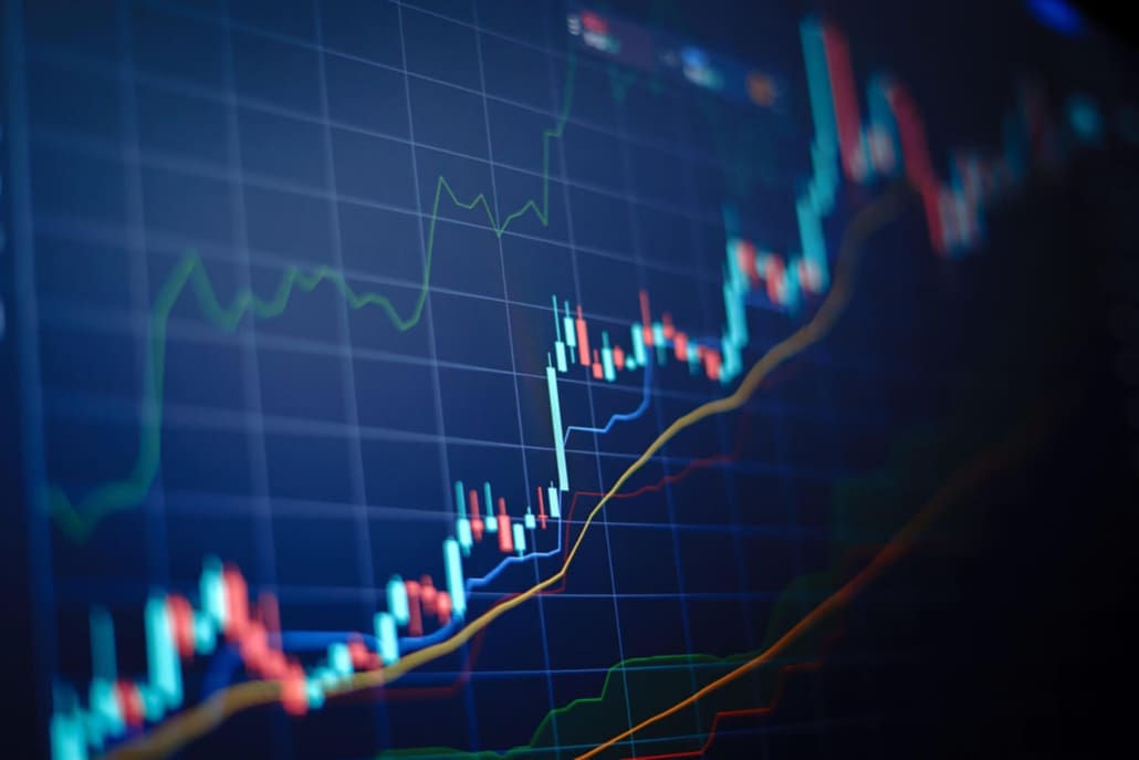 A close-up of a computer screen displaying a colorful financial chart with candlestick patterns, line graphs, and trend lines, illustrating the movement and analysis of stock or cryptocurrency prices for Share Valuations Sydney.