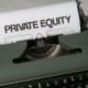 Close-up of vintage typewriter with 'PRIVATE EQUITY' on paper, business concept.
